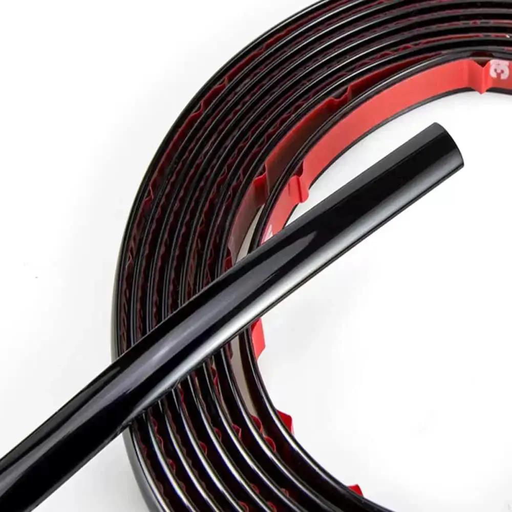 Glossy Black 12mm Automotive Trim Molding 25 Foot Self Adhesive for Vehicles close-up showing glossy surface and red backing.