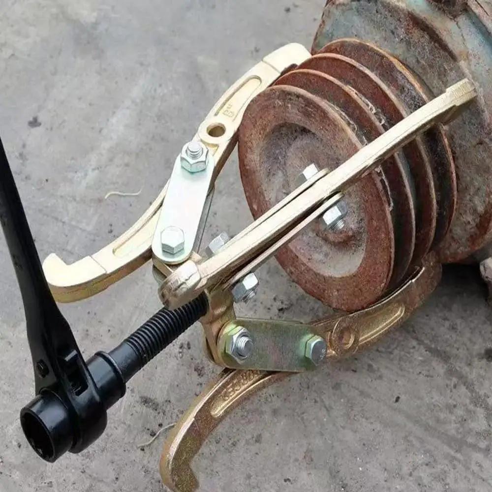 Convertible Three To Two And Three Jaw Gear Puller with reversible jaws pulling rusted pulley, ideal for tight spaces in auto repairs.