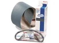 Sandpaper roll, packaged belts, and boxed industrial maintenance products on a plain background