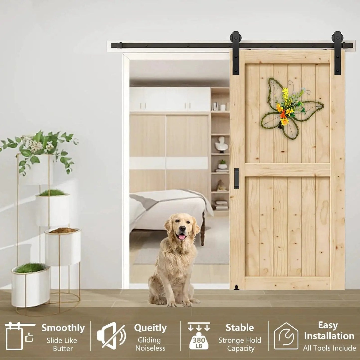 Installed sliding barn door with black I shape hangers and a flower decoration, showing heavy-duty hardware kit for 1 3/8 to 1 3/4 in doors.