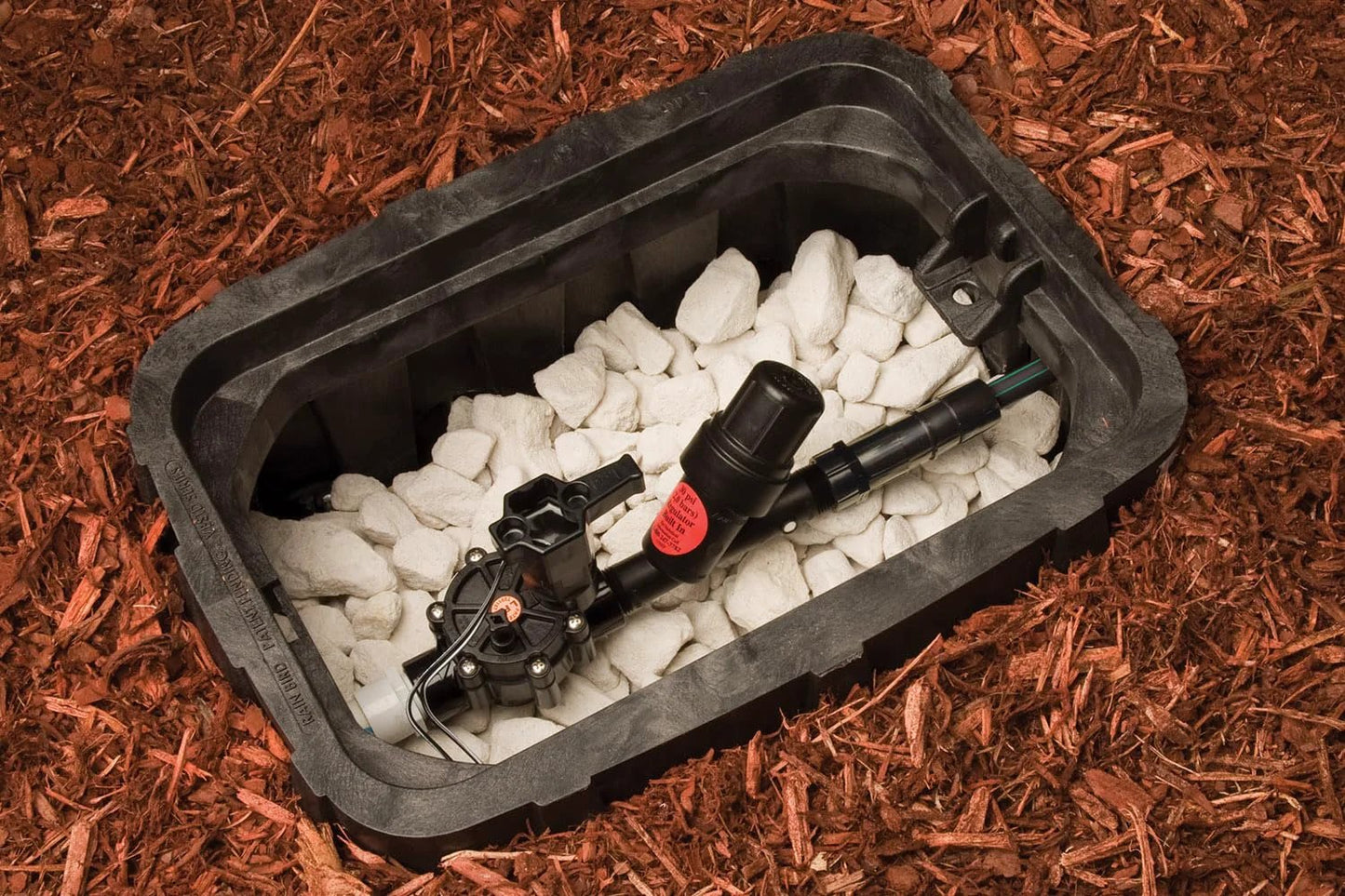 Inline Drip Irrigation Y Filter With 30 Psi Pressure Regulator And Stainless Steel 200 Mesh Filter For Downstream Protection And Fewer Parts Three Quarter Inch Male Pipe Thread Rain Bird installed in a garden bed box with mulch and gravel.