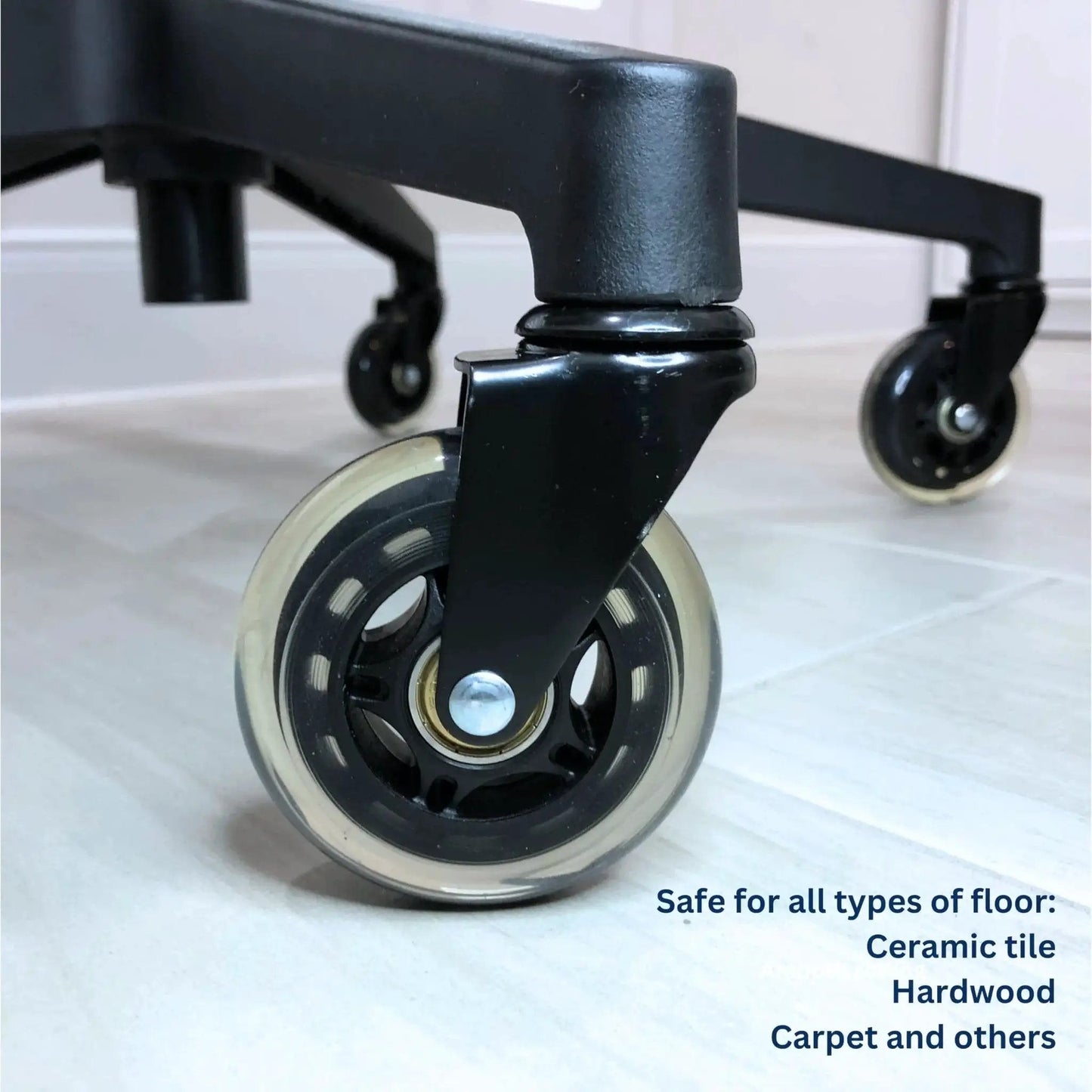 Close-up of installed office chair wheel casters, 3 inch roller blade type, heavy duty, non marking, showing smooth rolling on tile floor.