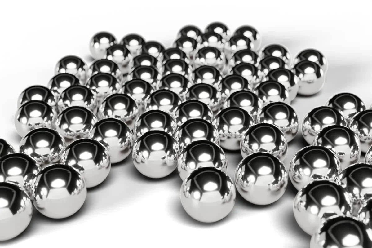 Shiny 8mm Bearing Balls 304 Stainless Steel G100 Precision Balls 55pc laid out, reflecting light on smooth surface.