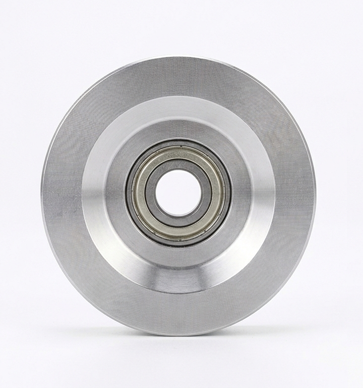 Two metal pulleys with bearings on a white background