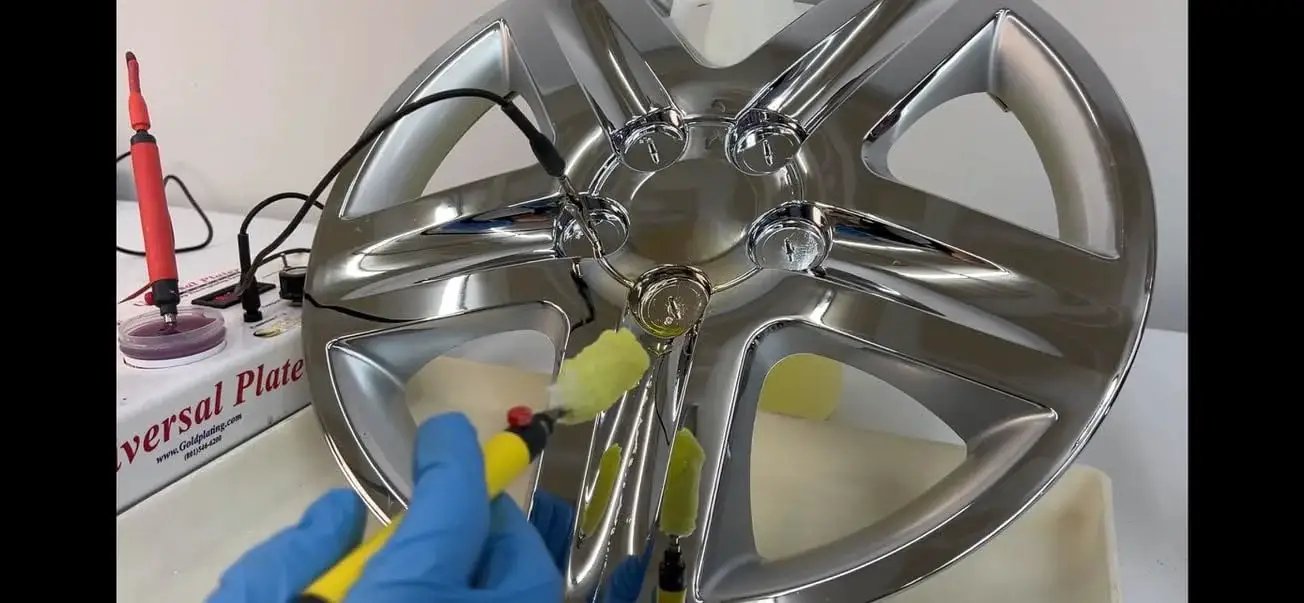 Applying 24K gold finish to a chrome automotive wheel with a Chrome Plating Kit With Brush System 24K Gold Solution Three Step Process.