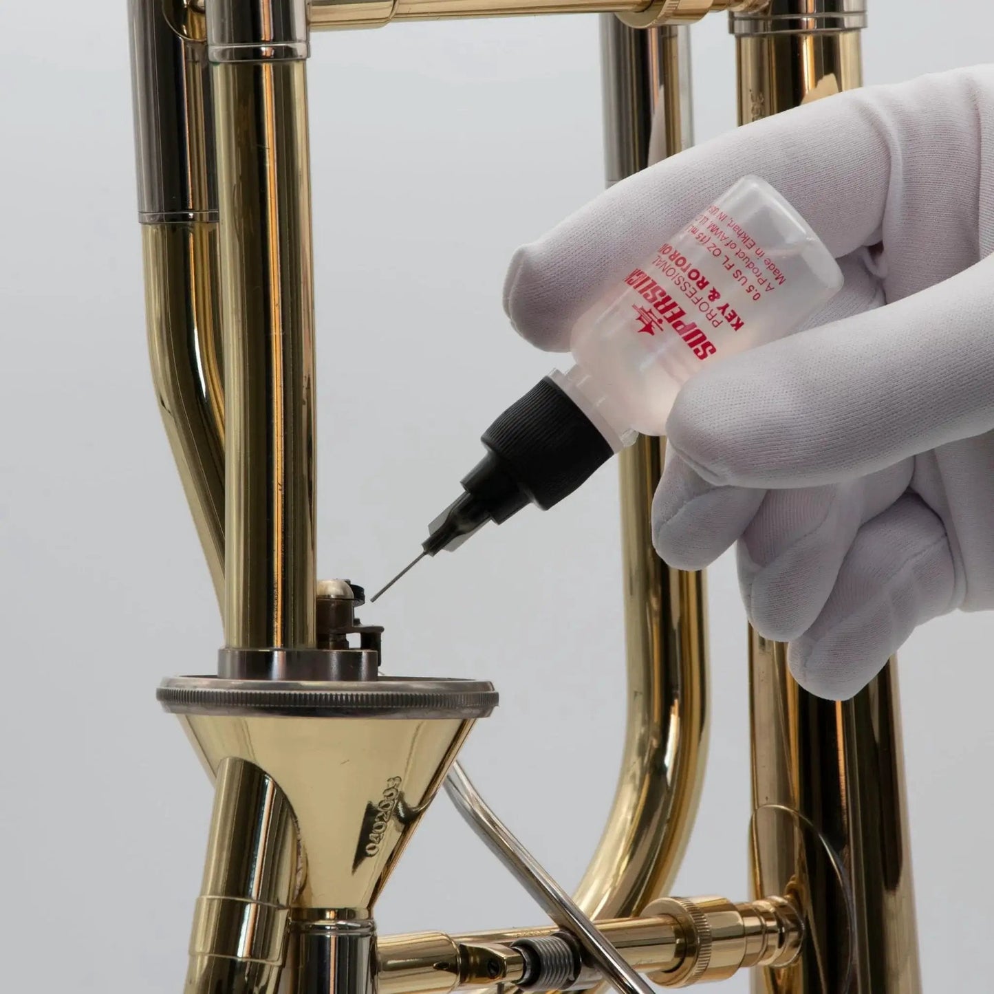 Applying Key And Rotor Oil With Precision Needle Tip Applicator For Brass And Woodwind Instruments on brass instrument valve