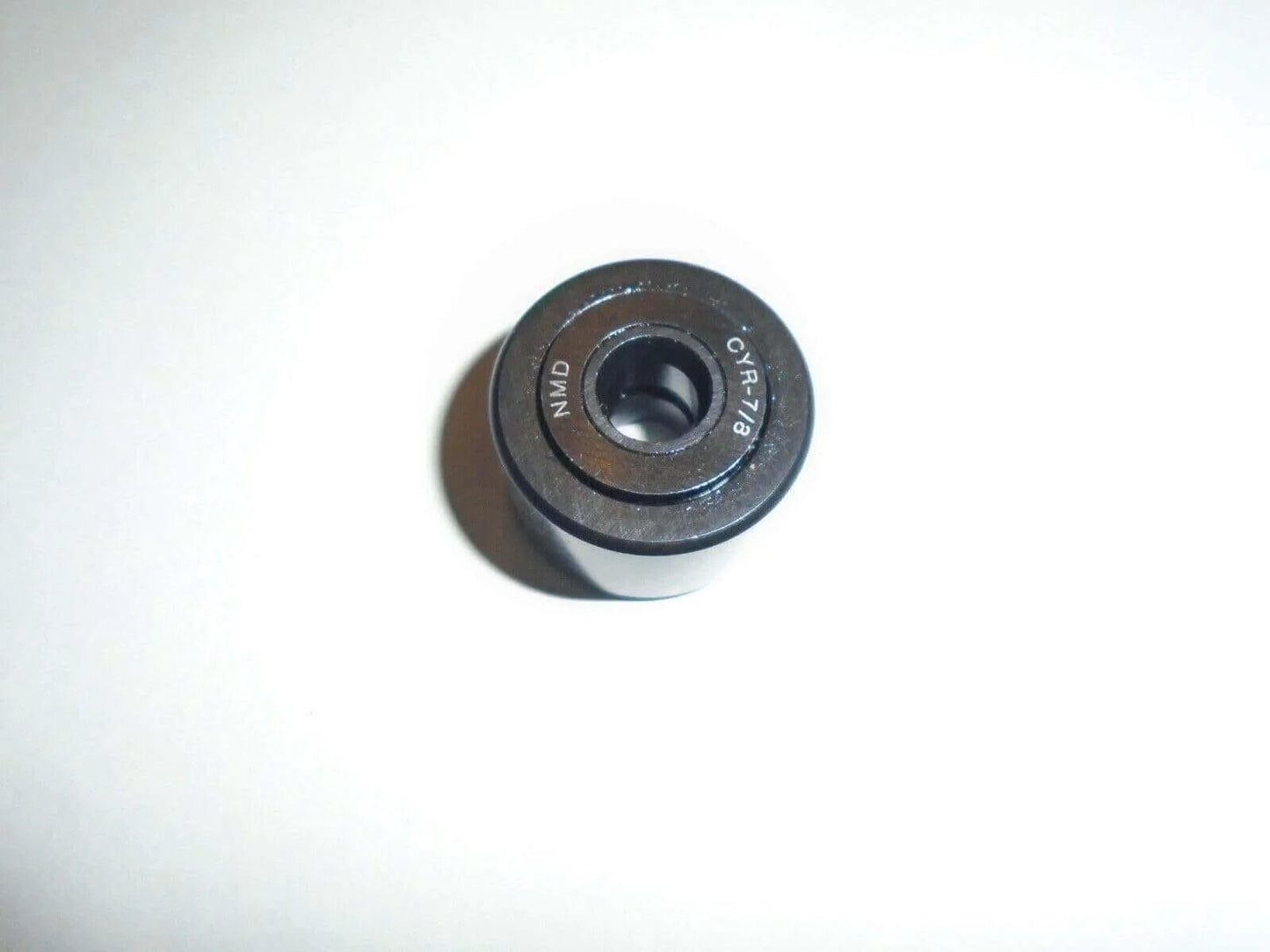 Top view of NMD CYR-7/8 Cam Follower Yoke Roller Bearing 1/4" ID X 7/8" OD X 9/16" Width BAB14 on white background.