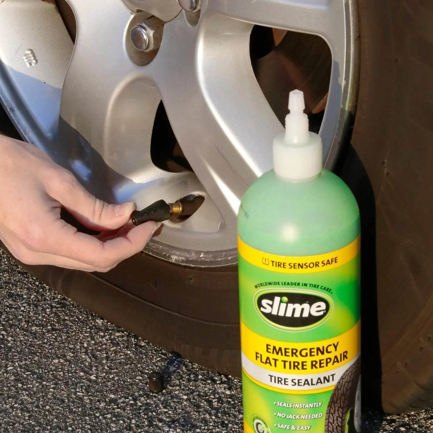 Person using Slime 10011 Flat Tire Puncture Repair Sealant, Emergency Repair for Highway Vehicles, Suitable for Cars/Trailers, Non-Toxic, eco-Friendly, 16 oz Bottle with tire