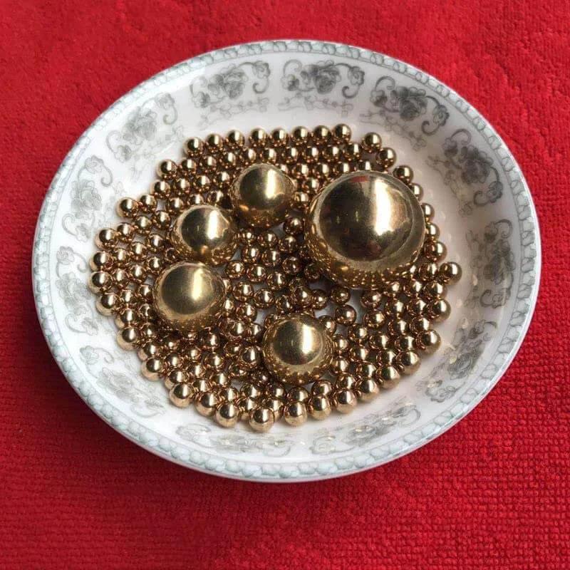 12mm 50pcs Solid Pure Copper Balls - Brass Ball Bead displayed on a decorative plate