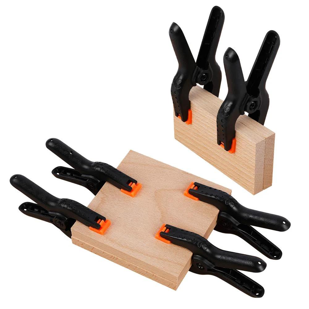 10 Pack 4.5 Inch Heavy Duty Plastic Spring Clamps for Crafts and Photography Backdrops, large clips securing wooden pieces.