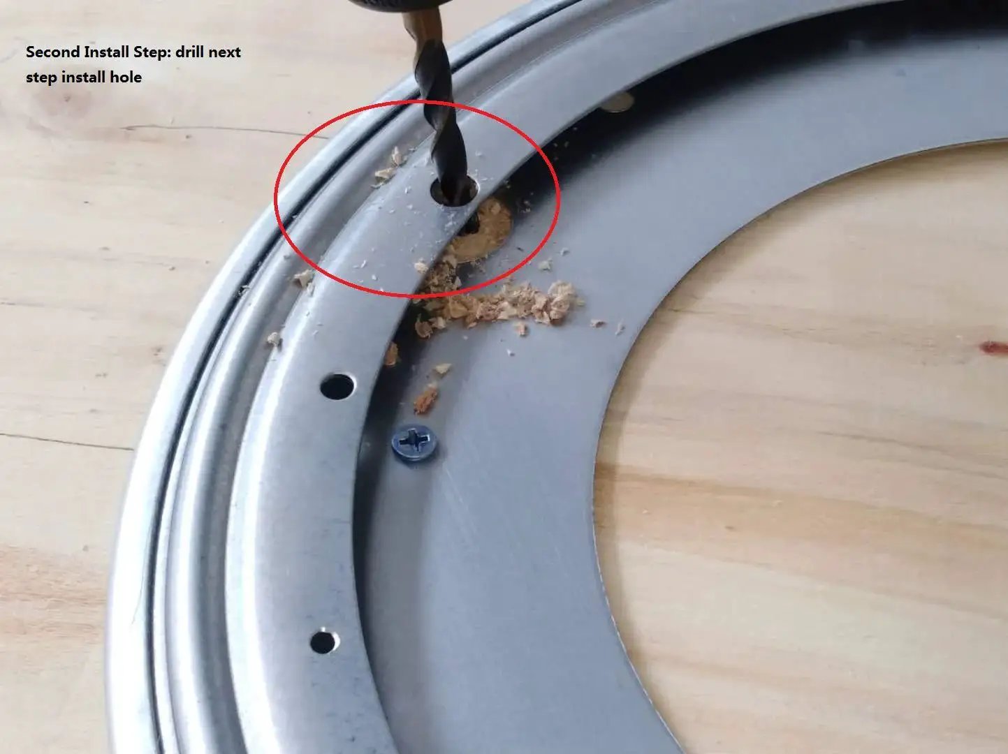 Installation of 12 Inch Lazy Susan Base Only For Glass Granite Or Wood Tables, showing drilling process on metal surface with drilled hole.