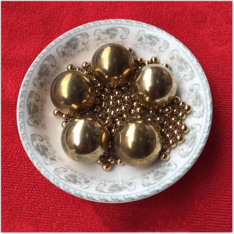 5 Brass ball beads displayed in a decorative bowl, from the 15.8mm 20pcs Solid Pure Copper Balls - Brass Ball Bead pack.