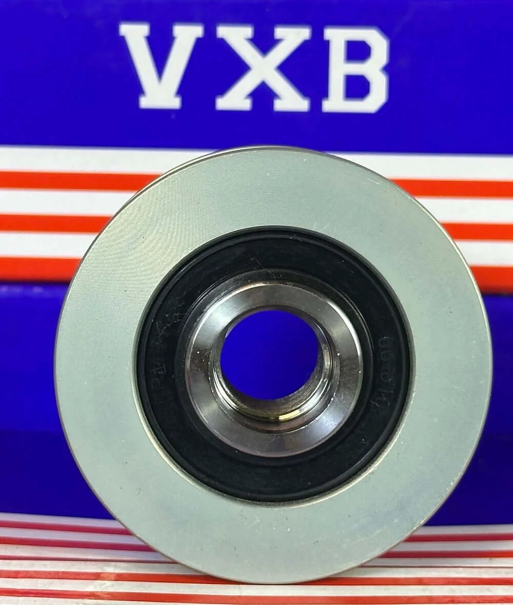F-553099 Alternator Freewheel Clutch Pulley Bearing front view showing shiny metal center and outer casing.