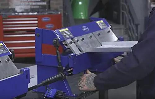 Person operating 24 Inch Box And Pan Sheet Metal Brake With Five Adjustable Fingers for small shops, bending sheet metal in a workshop.