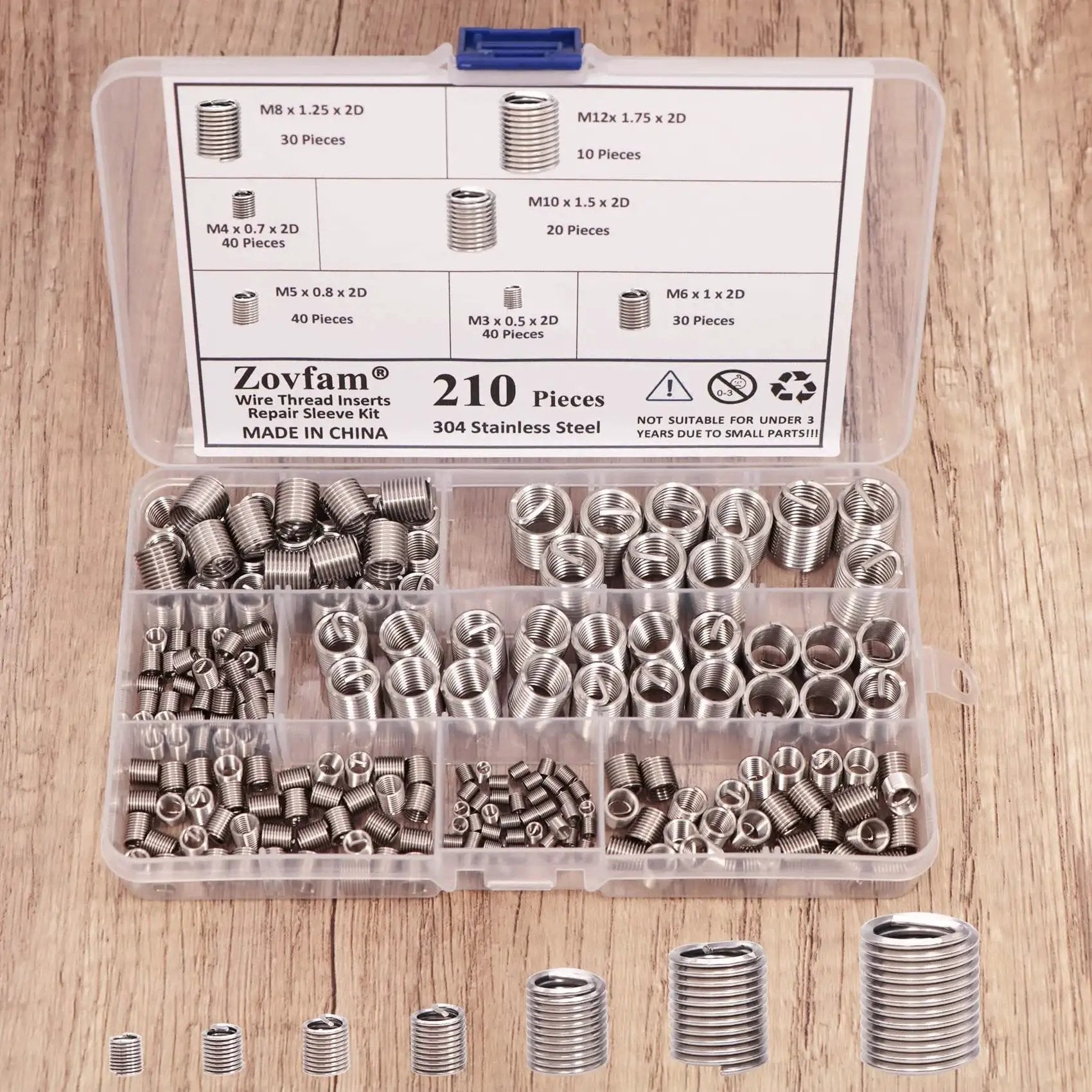 Pro Grade Wire Thread Inserts Kit in 304 stainless steel for metric M3–M12, 210 pieces, organized in a transparent case on wood surface.