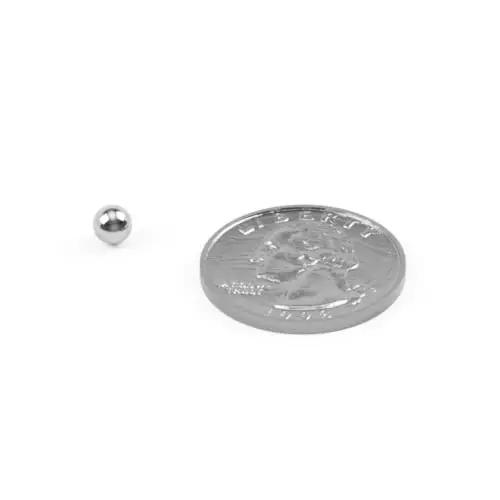 Three Sixteenth Inch 440 Stainless Steel Bearing Ball G25 Precision Grade AISI 440 next to coin for size comparison