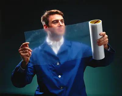 Man holding Hot Melt Brown High-Melt Roll 60 yd x 6 in Case - Shore 60A, Nitrile Phenolic Thermosetting Bonding Film sheet