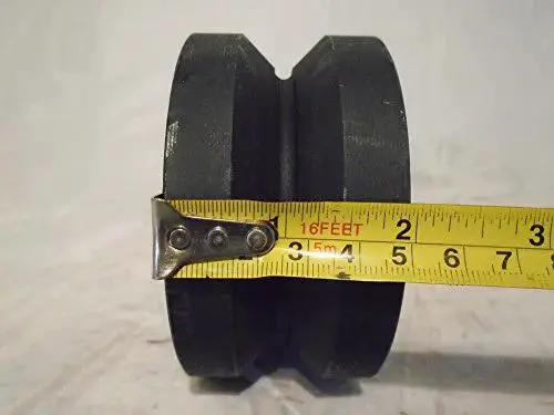 Heavy Duty 4X2 Inch V Groove Iron Steel Caster Wheel with tape measure for size reference, black finish for industrial use.