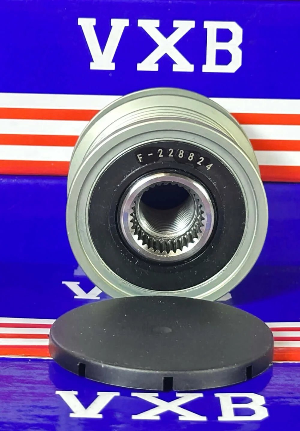 F-228824 Alternator Freewheel Clutch Pulley with protective cover viewed from the front against a colorful background.