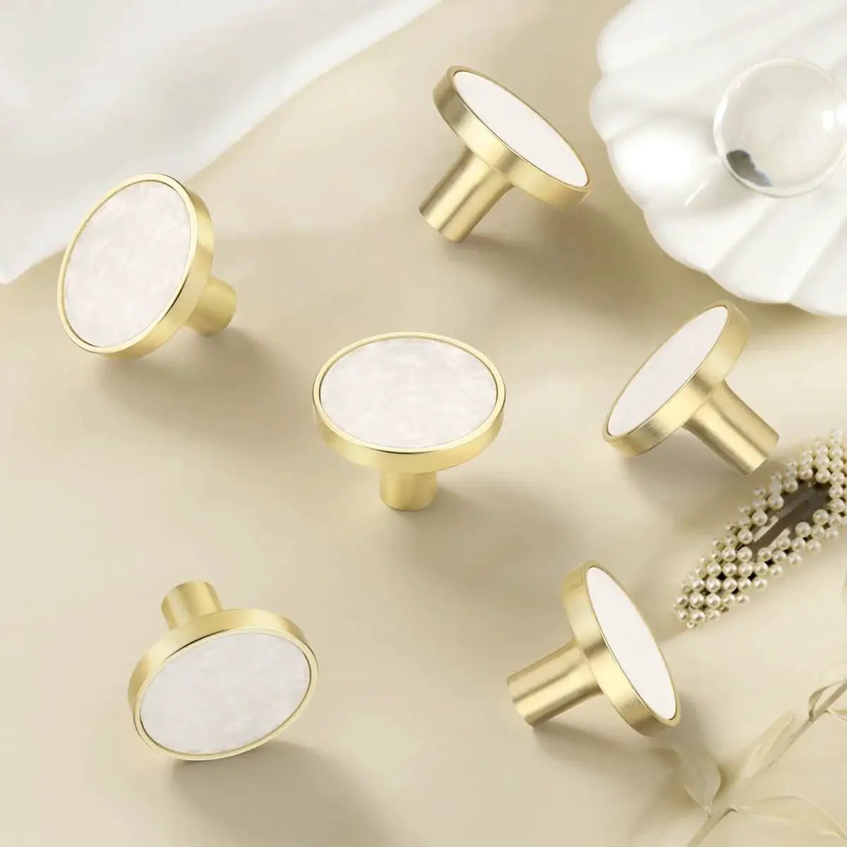 Gold and white round cabinet knobs on beige background, suitable for 12 Pack White Cabinet Knobs For Kitchen Cabinets And Dresser Drawers Drawer Pulls Easy Install Replacement Hardware Durable Smooth Finish Premium Quality Knobs For Home Renovation For Home Improvement
