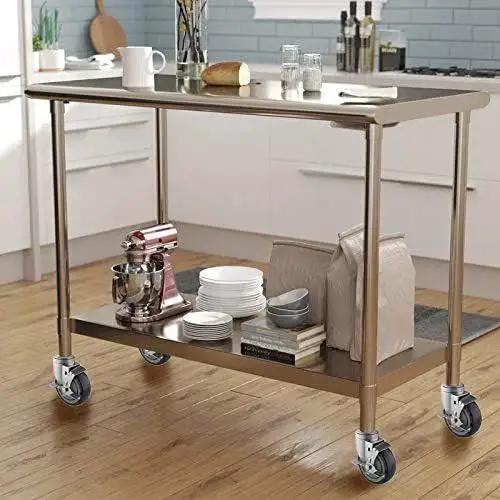 Stainless steel prep table on 4 inch casters with brakes in kitchen; features height-adjustable legs with 1-1/2 to 1-5/8 inch diameter fittings.
