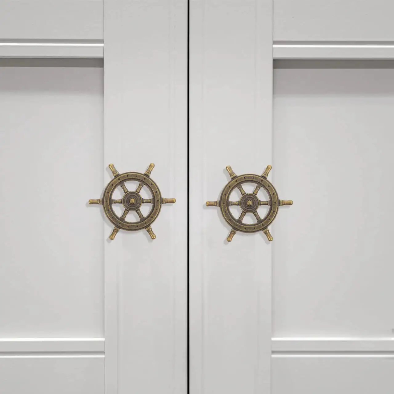 Two doors with Vintage Ship Wheel Anchor Cabinet Pulls Set Of 4 For Dressers And Wardrobes Nautical Style Decorative Handles installed.