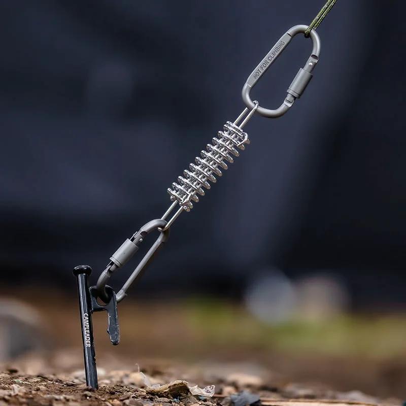 Heavy Duty 10 Pack 304 Stainless Steel Tent Springs For Windproof Tarp Awning Sun Shade Rope Tension Dog Chain Porch Swing And Outdoor Shelter Stabilization installed in ground.