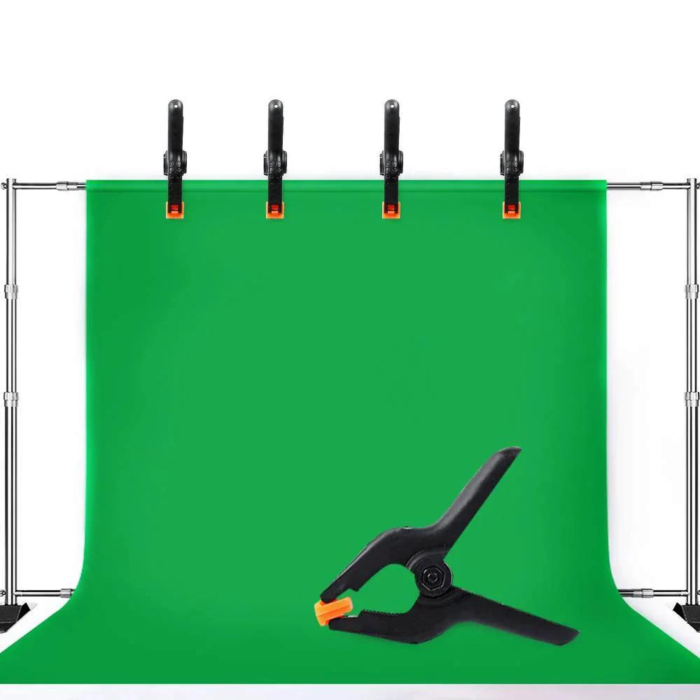 Four spring clamps holding a green backdrop, with a close-up of one Ten Pack Heavy Duty 4.5 Inch Plastic Spring Clamps For Crafts Backdrops Photography.