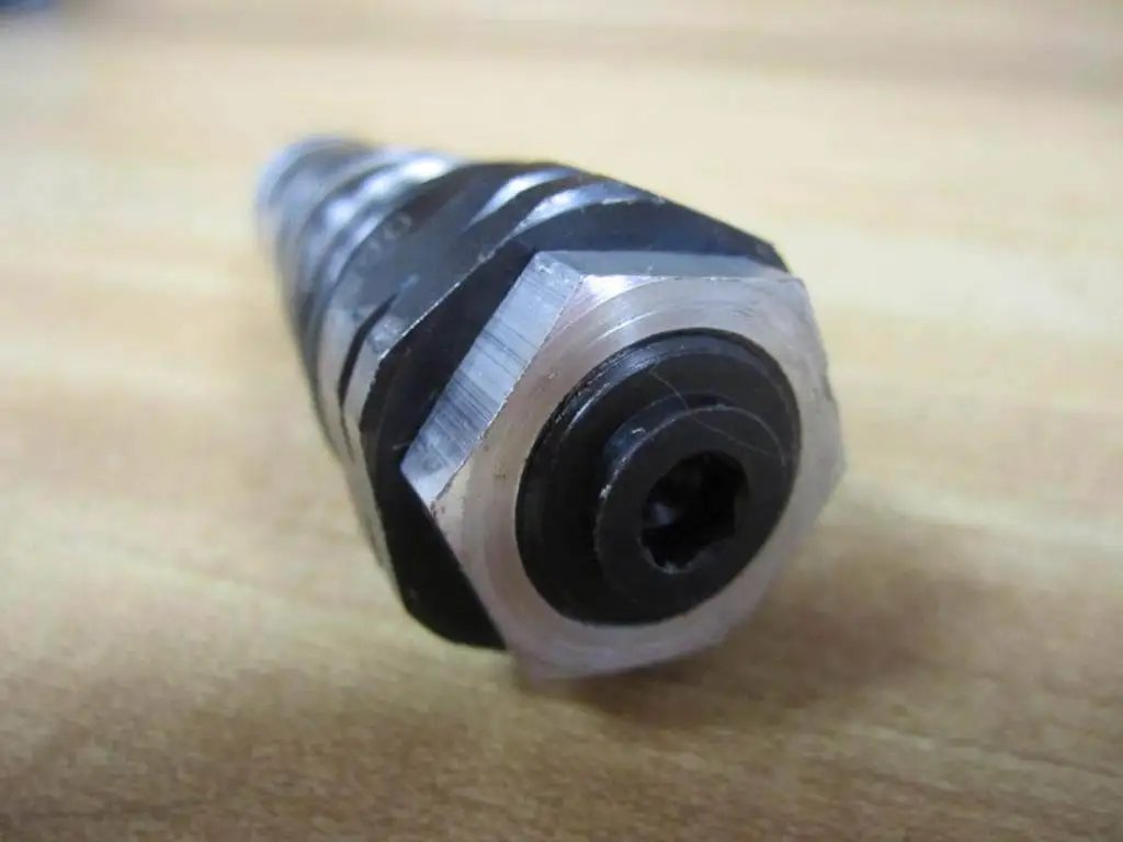 Close-up of Bosch Rexroth D620K2-12/100XYV Hydraulic Control Valve 3-1/2 Inch Long D620K212100XYV on wooden surface