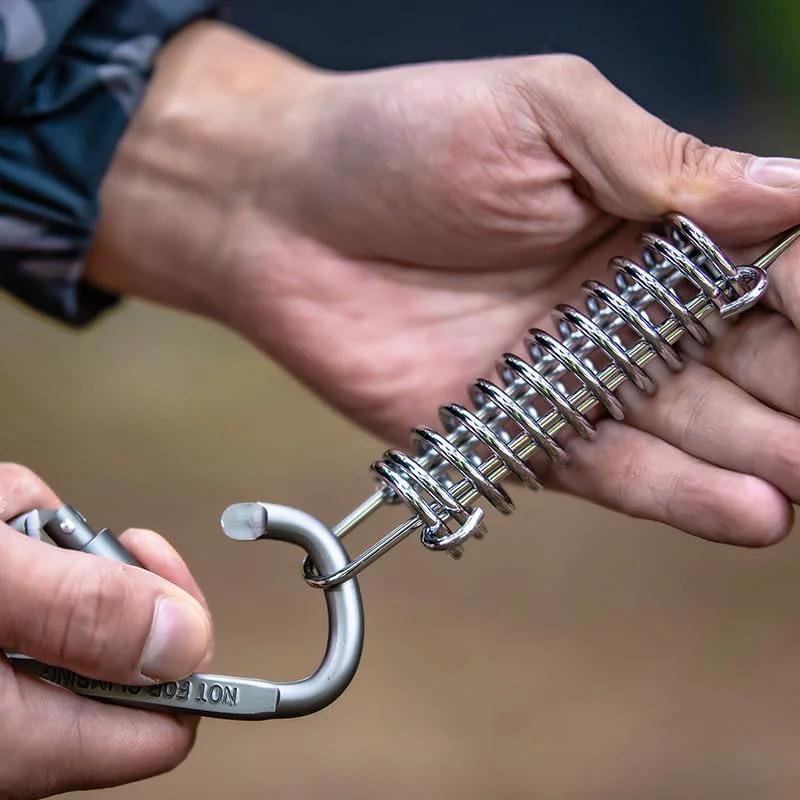 Close-up of installing Heavy Duty 10 Pack 304 Stainless Steel Tent Springs For Windproof Tarp Awning Sun Shade Rope Tension Dog Chain Porch Swing And Outdoor Shelter Stabilization.