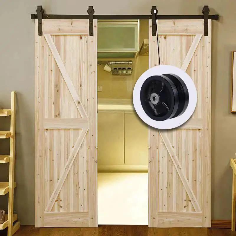 4 Inch By 1-1/2 Inch Cast Iron V Groove Caster Wheel With Straight Roller Bearing showcased in a barn door setting