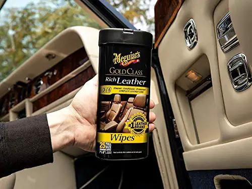 Gold Class Leather Wipes For Cars All In One Leather Cleaner Conditioner And Protector With Aloe Moisturizers 25 Large Wipes, front view, held in hand, inside car.
