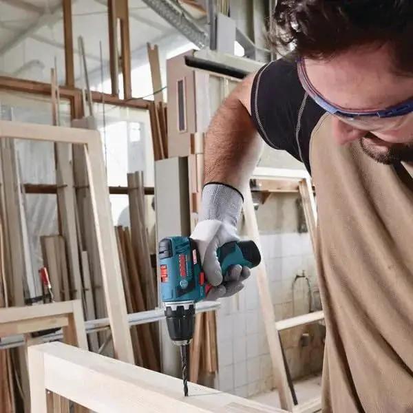 Man using 91 Piece Drilling And Driving Mixed Bit Set For Wood Metal And Masonry By Bosch With Driver Bits and Drill Bits