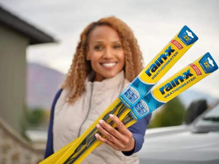 Person holding WeatherBeater 22 Inch Wiper Blades Pack of 2 With OEM Quality Durability in packaging