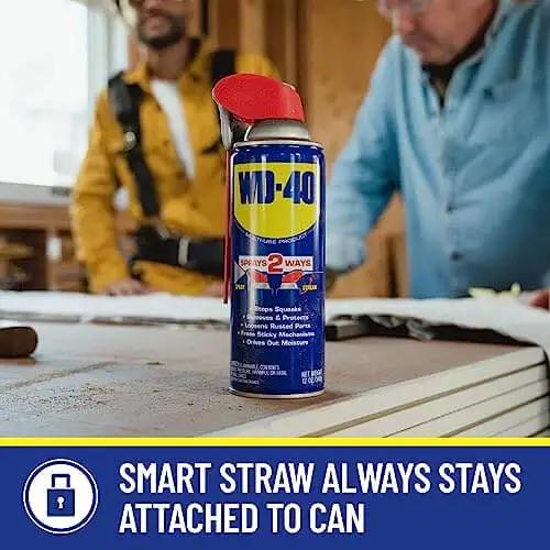 WD-40 can with smart straw in workshop setting, All Purpose Lubricant That Drives Out Moisture and Fights Rust
