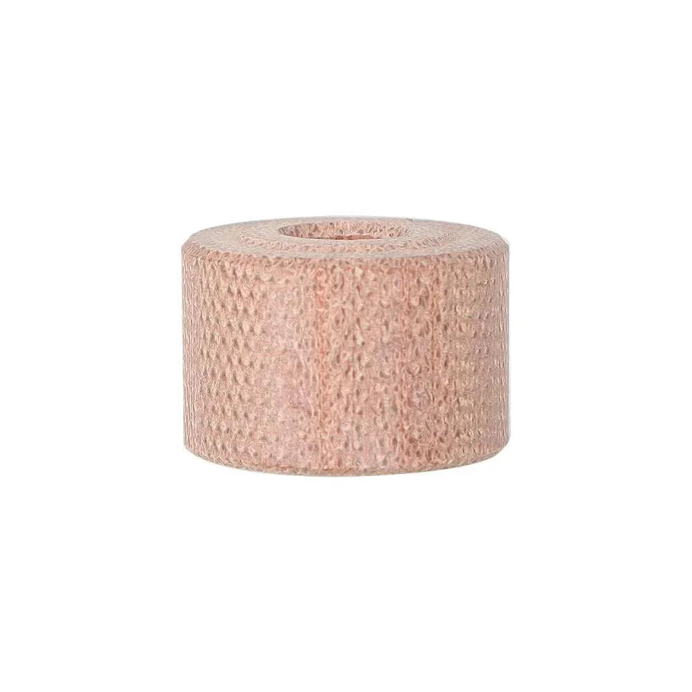 Roll of skin-colored cohesive bandage for medical use on injuries and sprains.