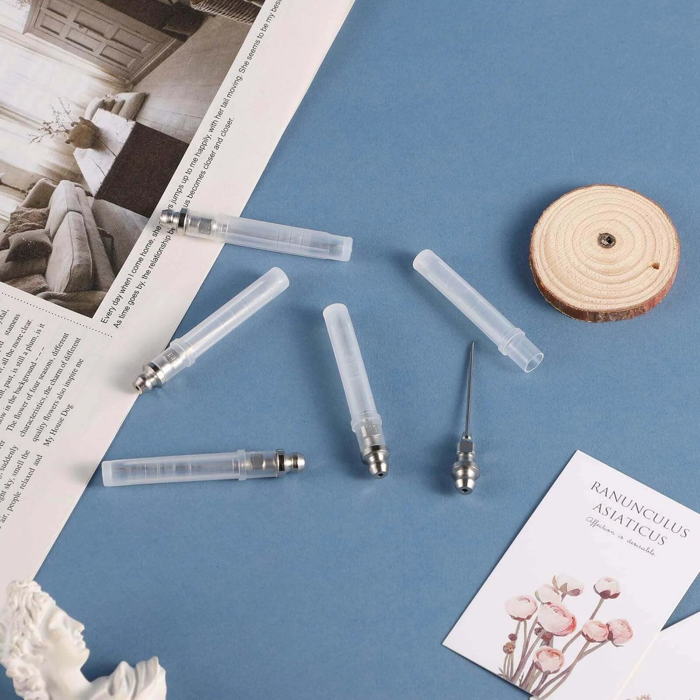 5pcs Grease Injector Needle set on a blue surface, showing small bearing grease needle nozzles and detachable tips for ball joints.