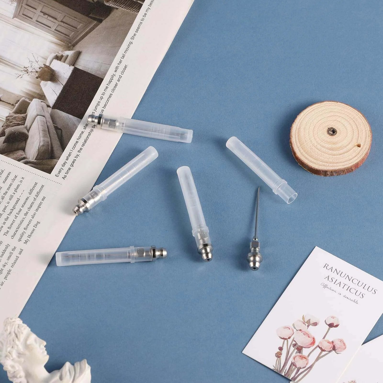 5pcs Grease Injector Needle set on a blue surface, showing small bearing grease needle nozzles and detachable tips for ball joints.