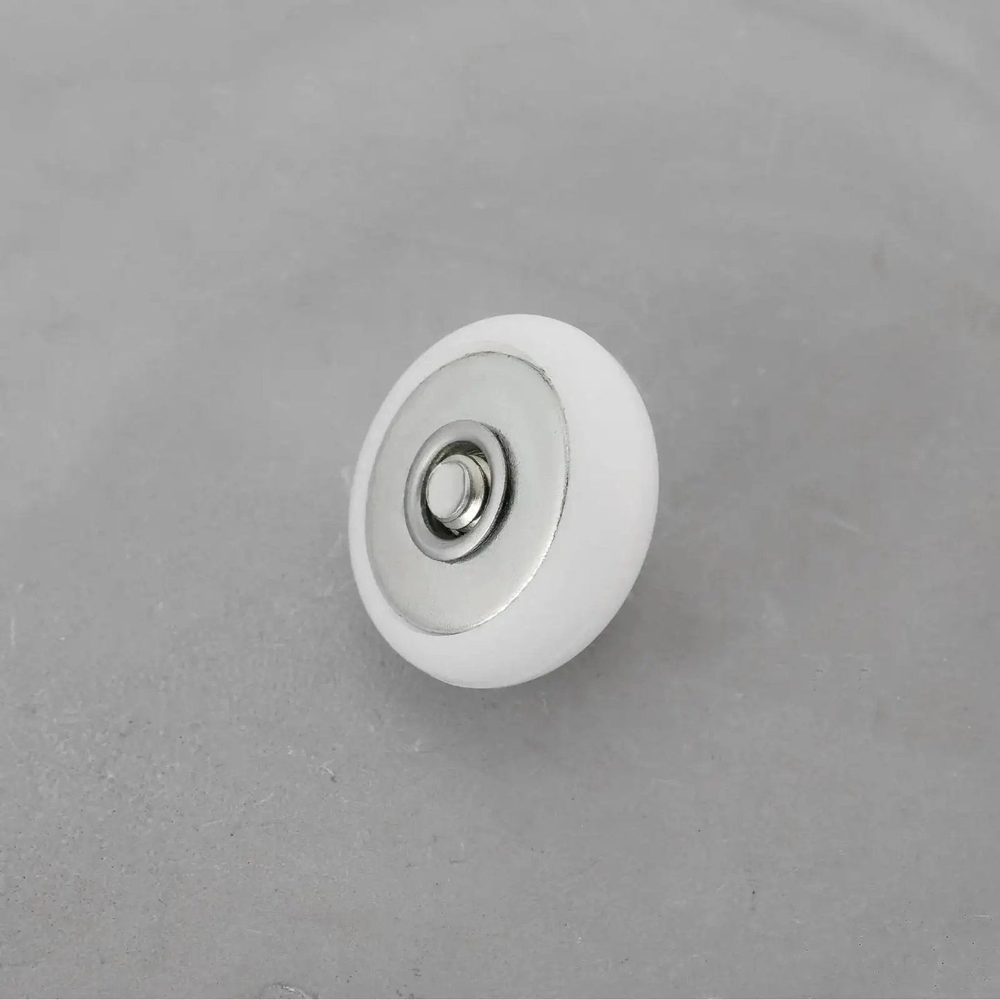Close-up of a single 8 Piece Oval Edge Shower Door Roller with 19mm diameter and 6mm thickness for glass shower doors.