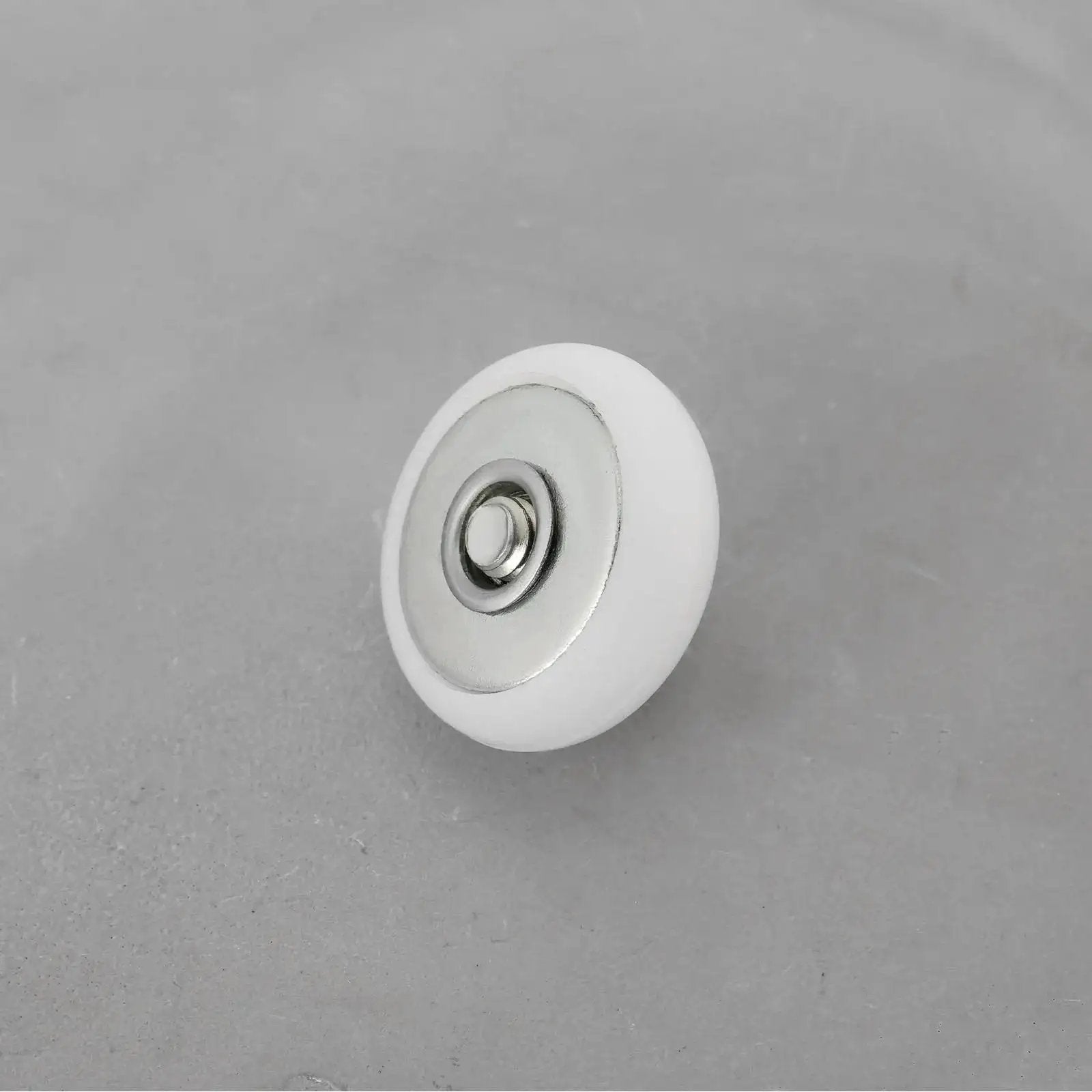 Close-up of a single 8 Piece Oval Edge Shower Door Roller with 19mm diameter and 6mm thickness for glass shower doors.