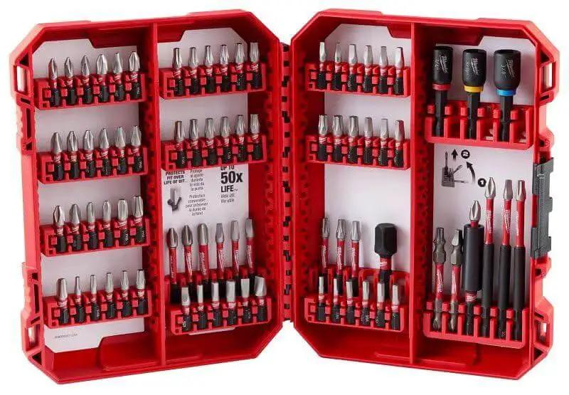 Open red case with Shockwave Impact Driver Bit Set 74 Piece for Tough Jobs With Geometric Shock Absorption Forged Tips Proprietary Steel Heat Treat Process Over 130 Value by Milwaukee displayed.