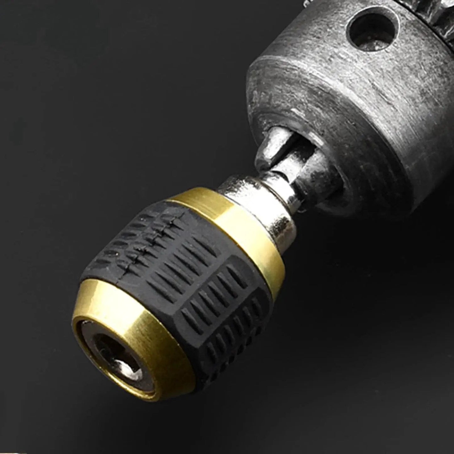 Close-up of Quick Release Hex Shank Bit Holder With Self Locking Magnetic Drill Extension showing silver and black build with gold accents.