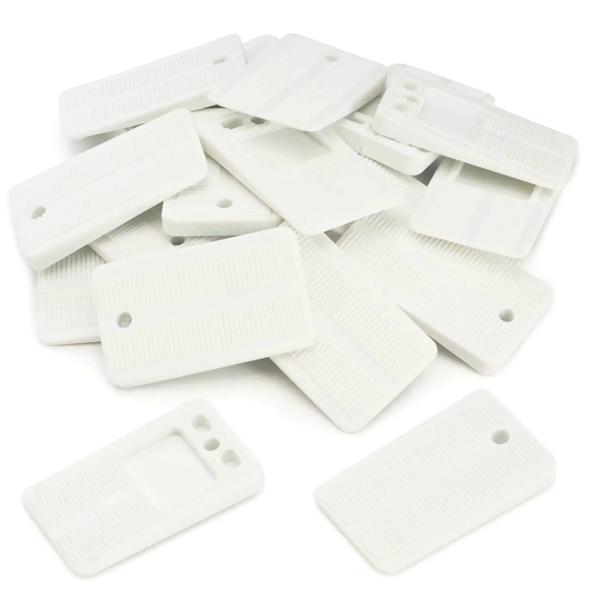 Flexible Wedge Shims For Furniture And Toilet Leveling 40 Pack Durable Plastic Adjustable Shims scattered on surface
