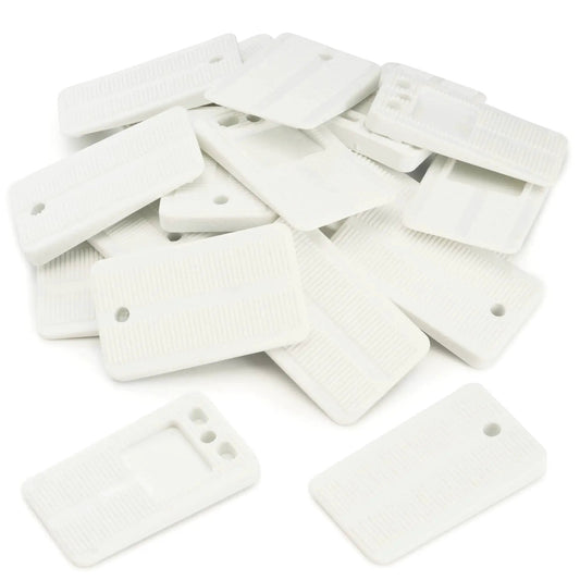 Flexible Wedge Shims For Furniture And Toilet Leveling 40 Pack Durable Plastic Adjustable Shims scattered on surface