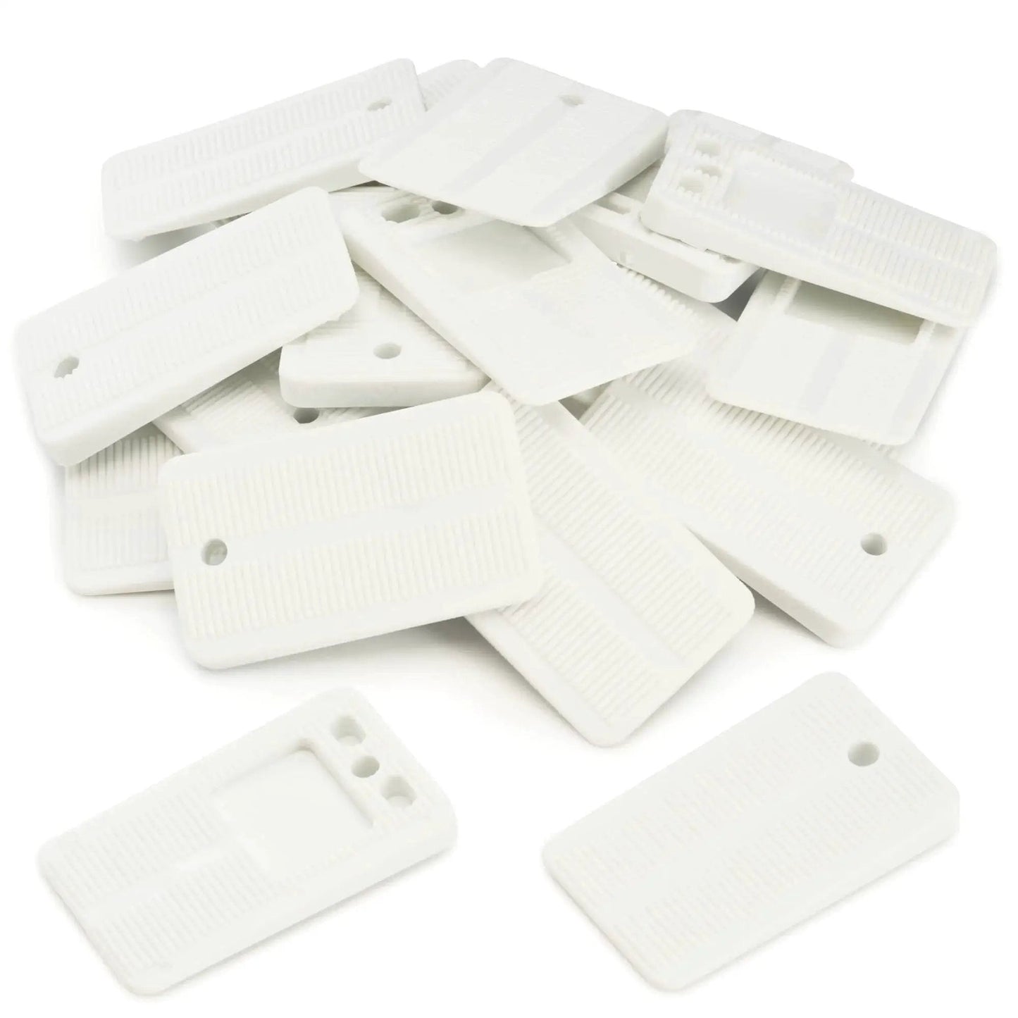Must Have Leveling Shims For Furniture And Home Improvement Nonslip Multi Purpose Wedges For Tables Desks Cabinets And Toilet Shims Deliver Quick Easy Stability 20 Pack White Qualihome Pro Grade, showing a pile of white plastic shims.
