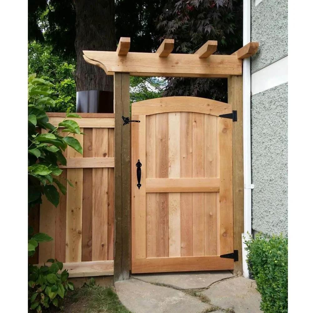 Wooden garden gate installed with Heavy Duty Gate Hardware Kit With Self Locking Gate Latch 6 Inch T Strap Hinges, rustic setting.