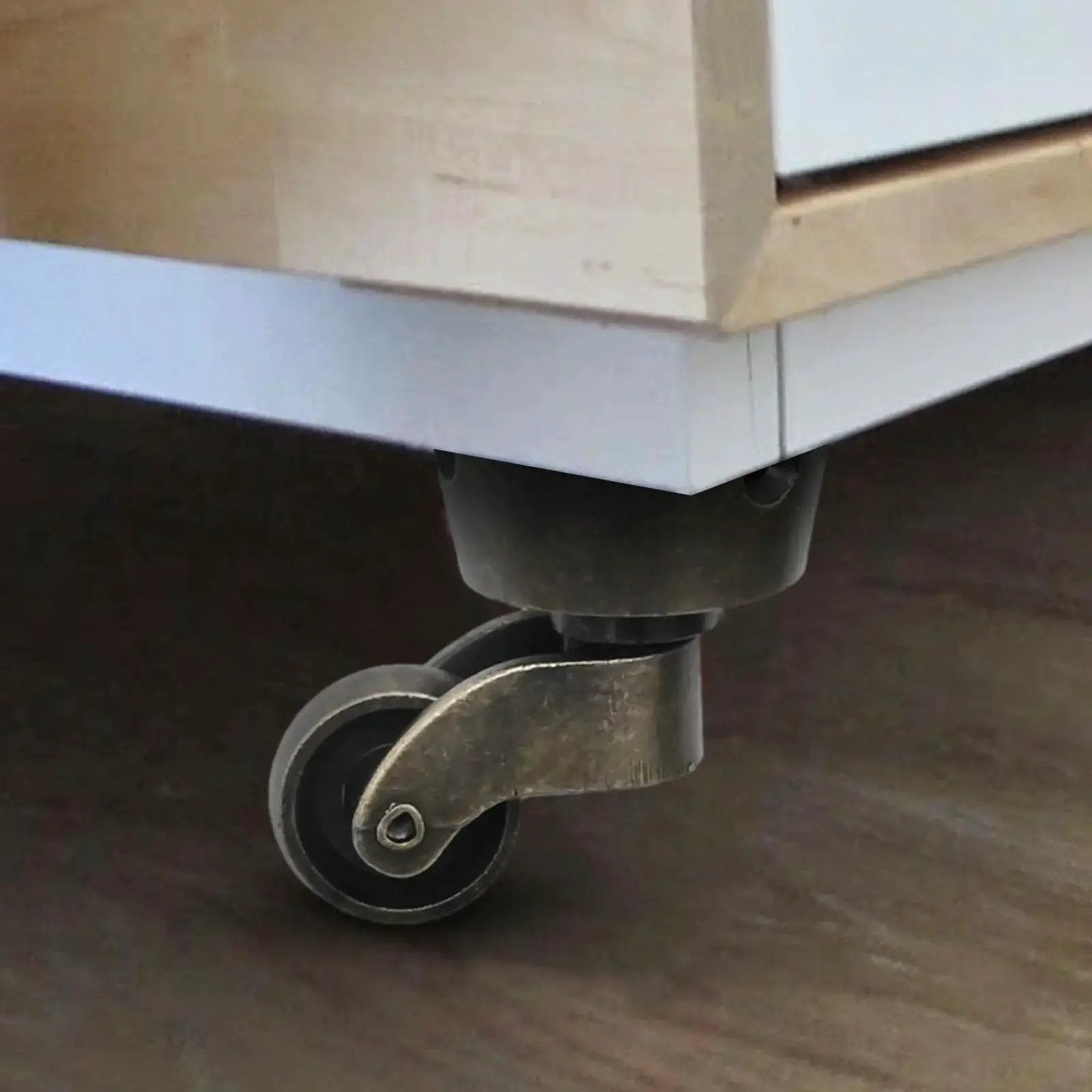 Installed two pack vintage zinc alloy swivel caster wheels with antique green bronze finish under furniture piece