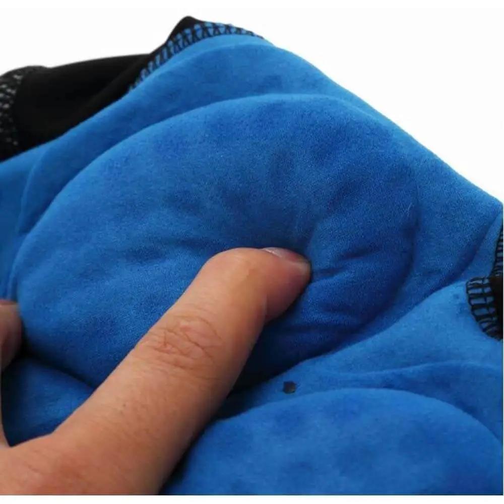 Close-up of a finger pressing into a blue cushioned pad, highlighting its softness and texture, surrounded by a black mesh border.