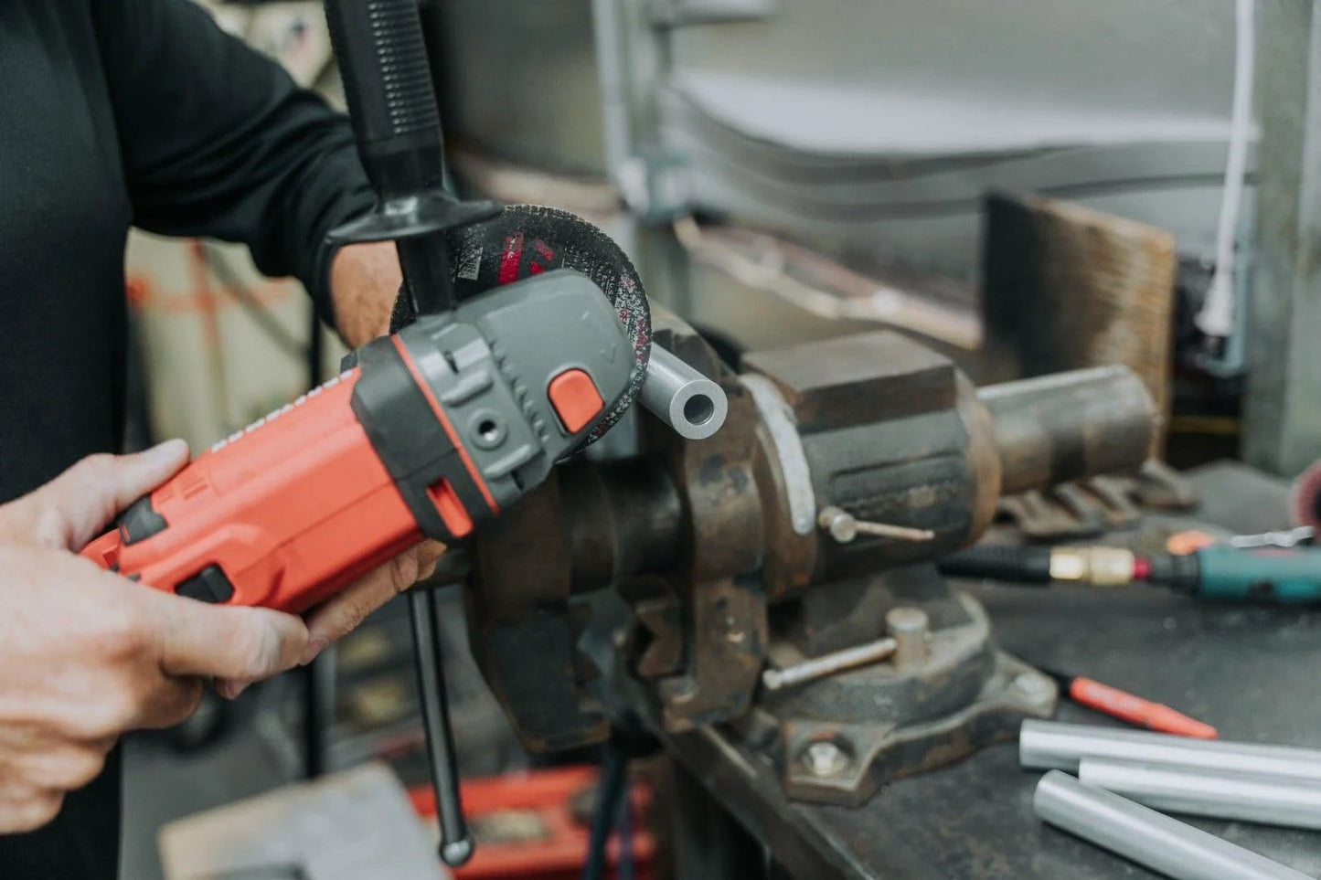 Worker using power tool on Three Eighth Inch Outer Diameter Round Steel Tube Spacer Eight Inch Long Two Pack For Diy Projects