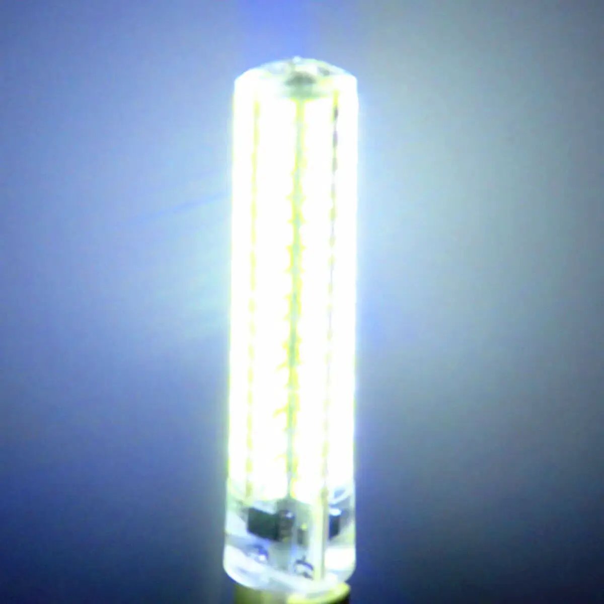 Close-up of a glowing LED bulb against a dark background, showcasing its bright light and cylindrical shape.